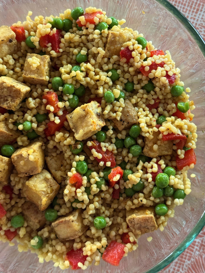 Curried couscous with baked tofu and peas